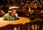 Intimate candlelit event table with flowers in a spacious venue