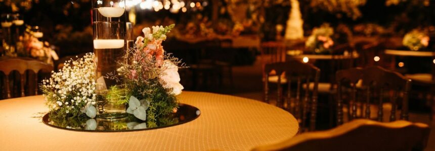 Intimate candlelit event table with flowers in a spacious venue